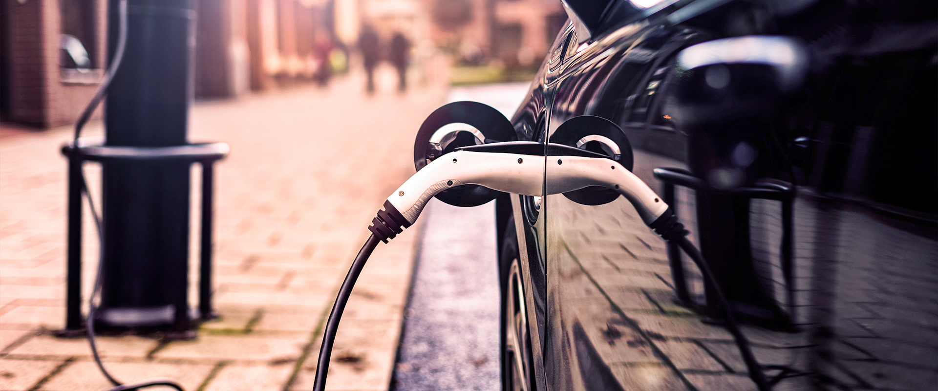 Electric vehicle charging at a charging point on the street