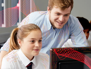 Teacher and pupil looking at a computer